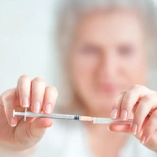 Healthcare provider holding syringe ready for spinal therapy injection
